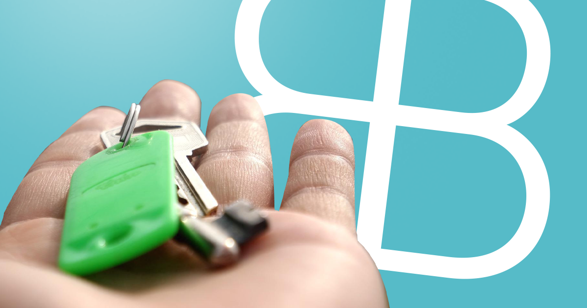 Hand holding keys with boon brokers logo in background