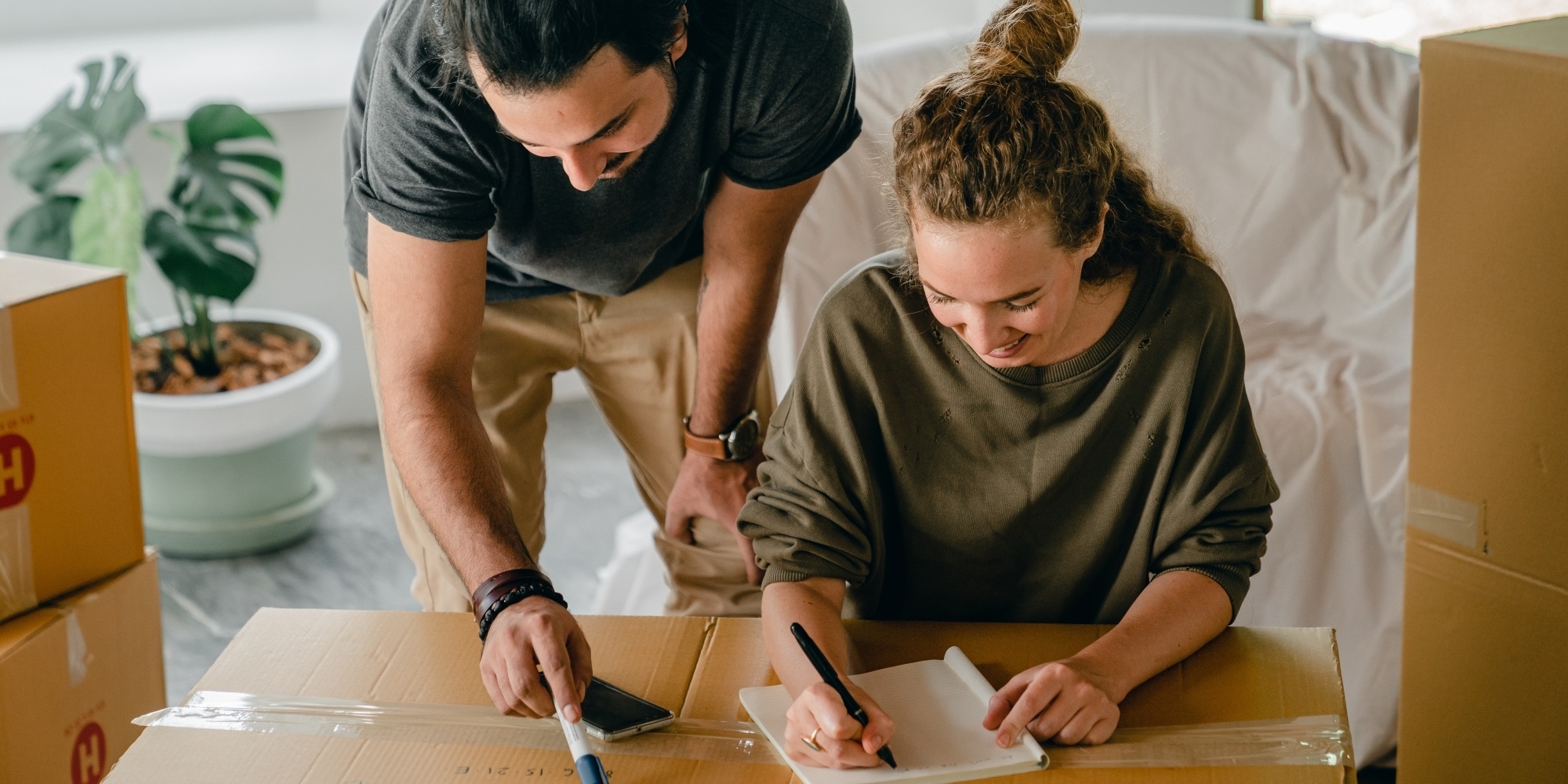 young couple packing boxes