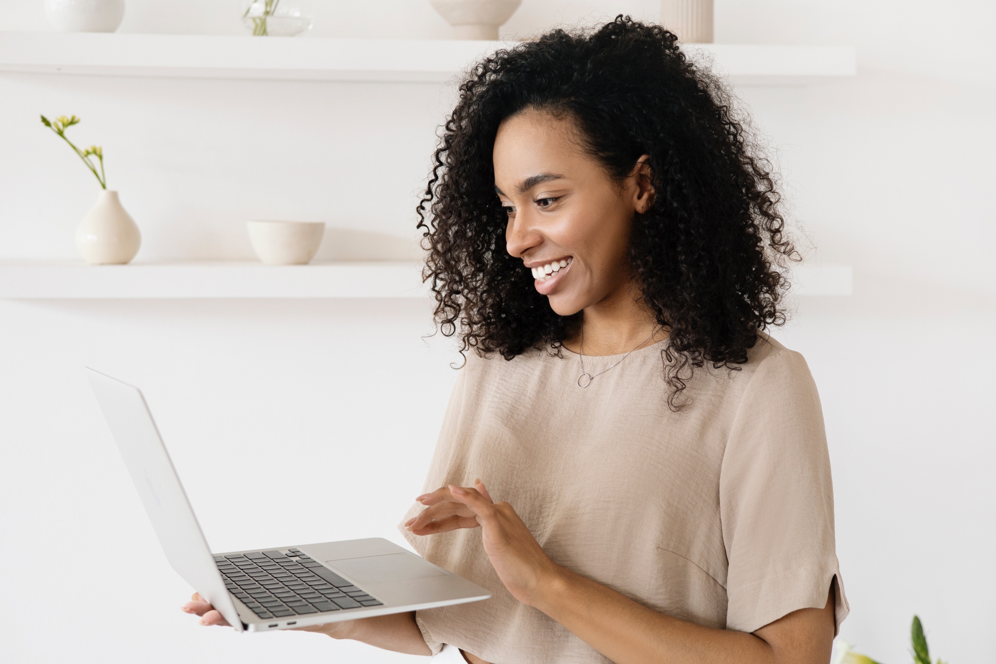 young woman researching first time buyer mortgages on computer