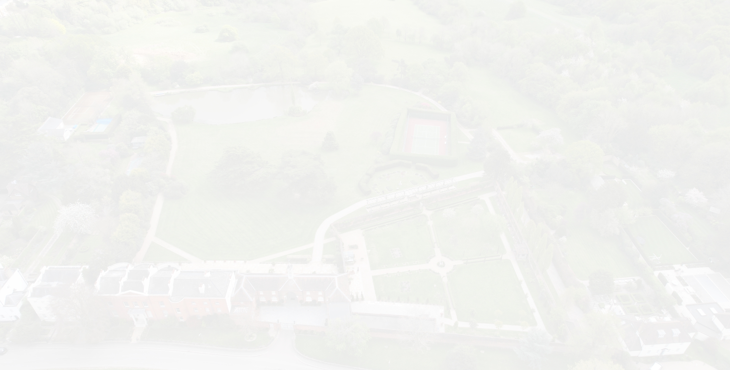A birds-eye view of a neighbourhood in Barnet with Open green spaces and a row of large semi-detached houses
